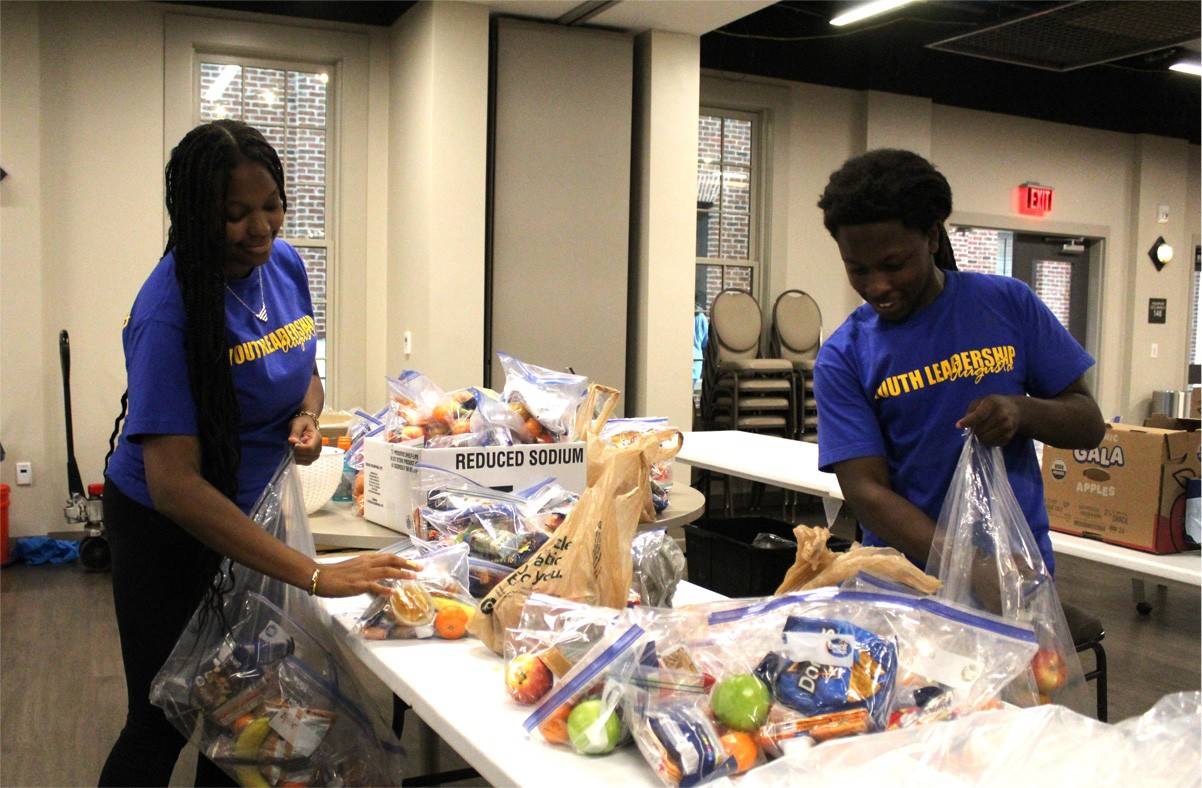 Two The Renewed Hope Foundation volunteers organize and distribute food supplies to those affected by Hurricane Helene
